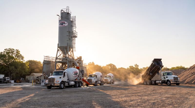White Estrada Ready Mix trucks loading at the batch plant